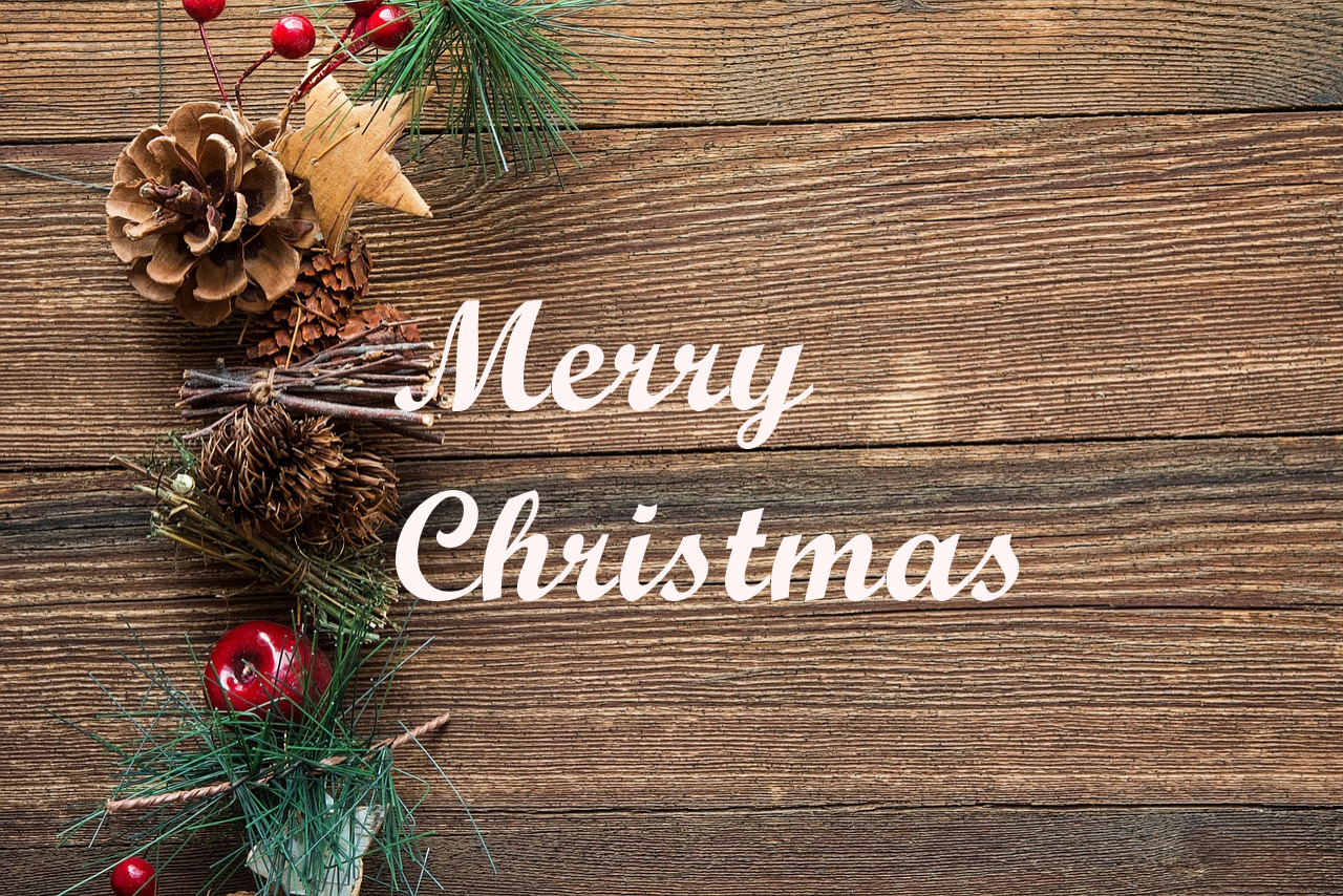 A wooden background with a border of pinecones and berries. Text reads Merry Christmas.