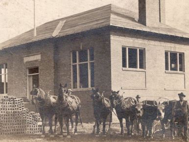 horses and building materials in front of construction of kinsman library