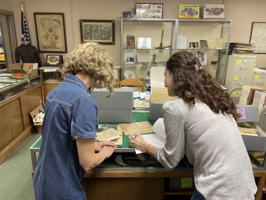 two women looking at documents