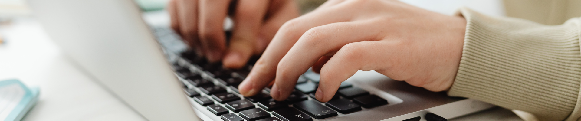 A women typing on a laptop.