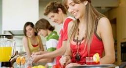 A picture of 4 teens cooking at a stove