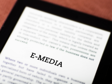 Kindle with the title Emedia and small blurred words on the screen